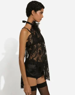 Asymmetrical lace top with flower detail on neck