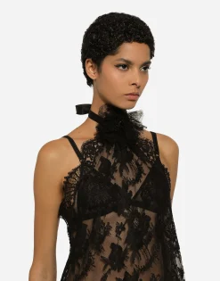 Asymmetrical lace top with flower detail on neck
