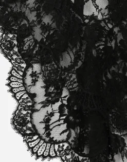 Asymmetrical lace top with flower detail on neck