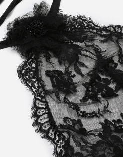 Asymmetrical lace top with flower detail on neck