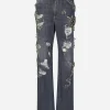 Denim jeans with ripped details and appliqués