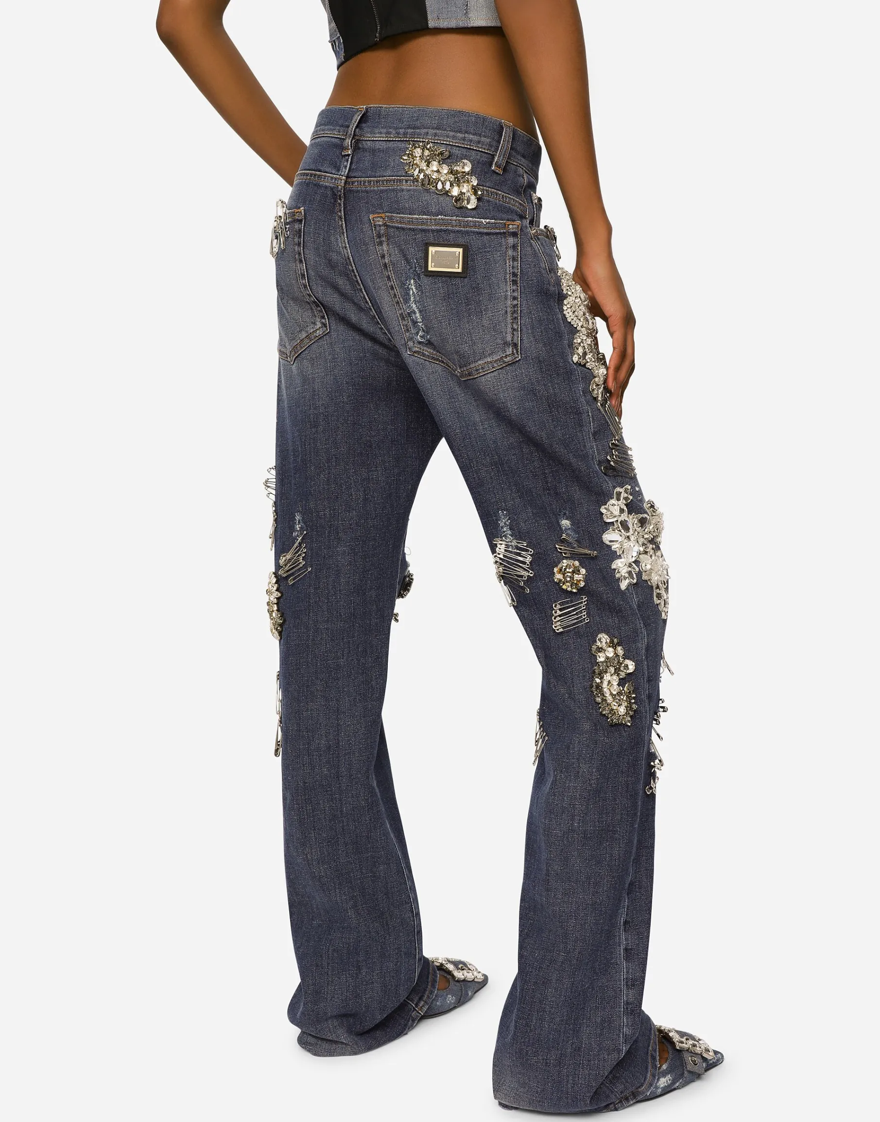 Denim jeans with ripped details and appliqués
