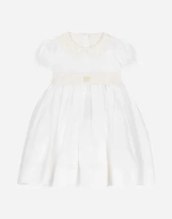 Empire-line muslin christening dress with short sleeves