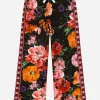 Jersey jogging pants with floral print over a black background