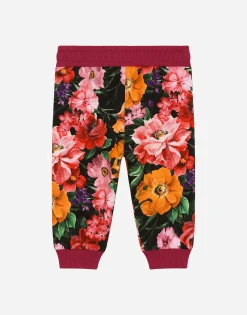 Jersey jogging pants with floral print over a black background