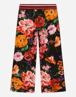Jersey jogging pants with floral print over a black background