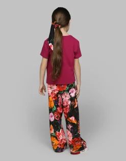 Jersey jogging pants with floral print over a black background