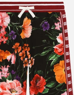 Jersey jogging pants with floral print over a black background