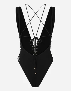 One-piece swimsuit with plunging neckline and lacing and eyelets