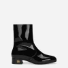 Patent leather ankle boots with branded heel