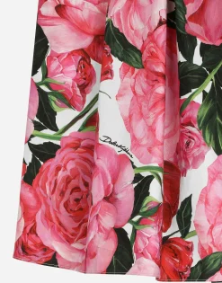 Poplin dress with rose print over a white background