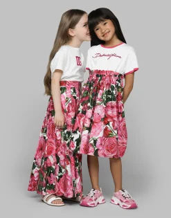 Poplin dress with rose print over a white background