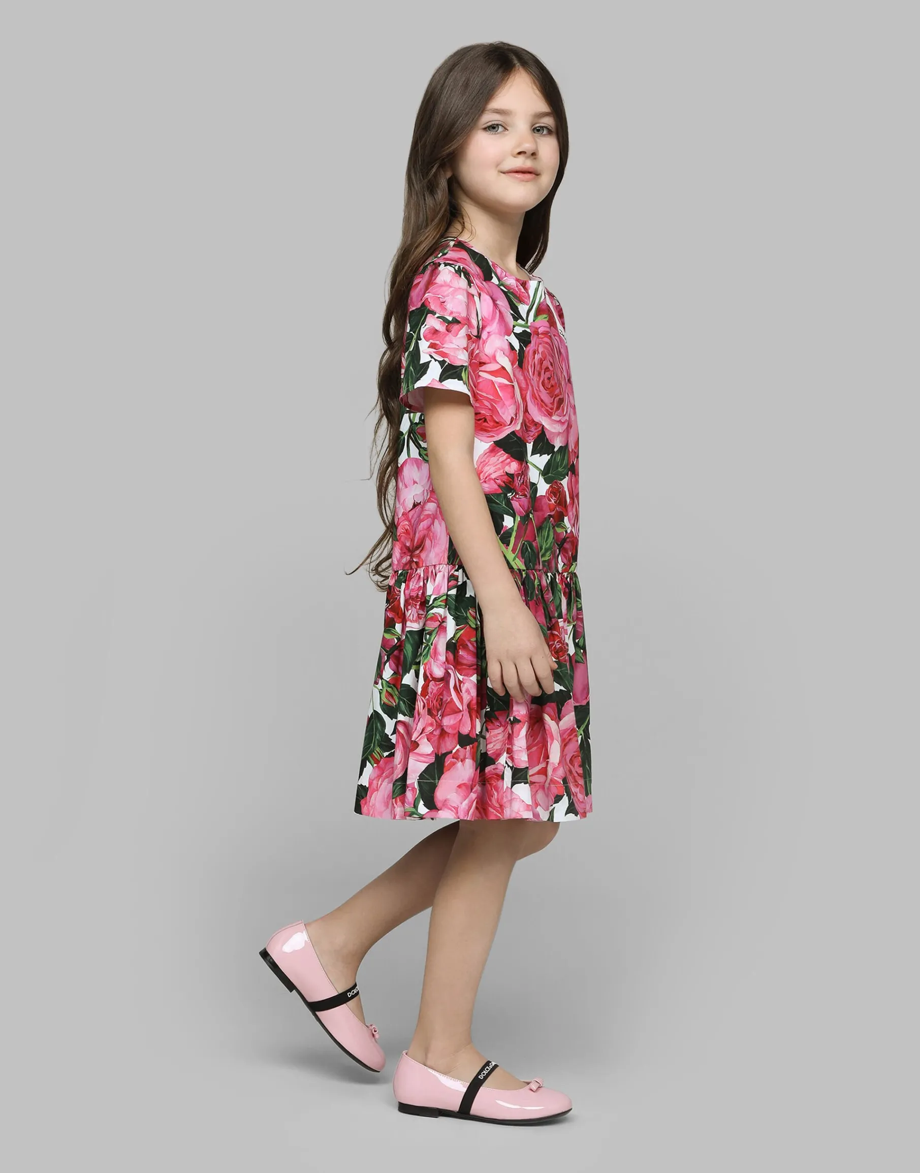 Poplin dress with rose print over a white background