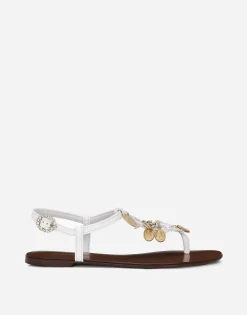 Raffia thong sandals with embroidered votive medallions