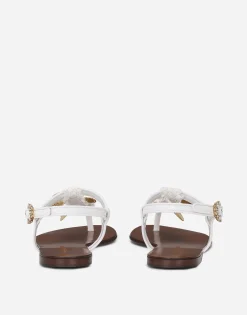 Raffia thong sandals with embroidered votive medallions