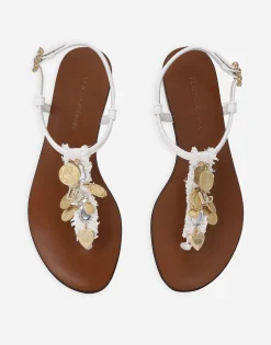 Raffia thong sandals with embroidered votive medallions