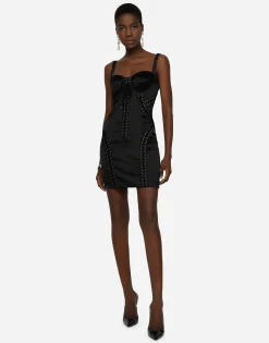 Short satin dress with laces and eyelets