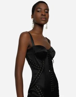 Short satin dress with laces and eyelets