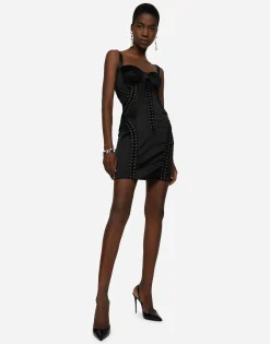 Short satin dress with laces and eyelets