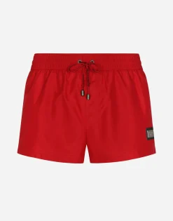 Short swim trunks with branded tag