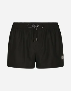 Short swim trunks with branded tag