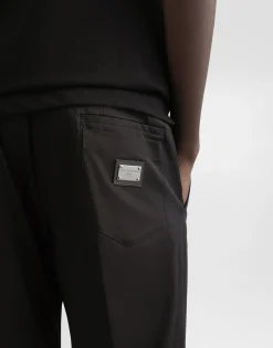 Stretch cotton pants with branded tag